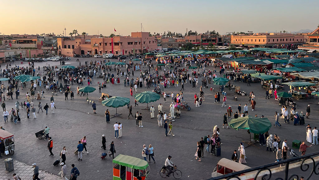 A busy medina in Marrakech at sunset.